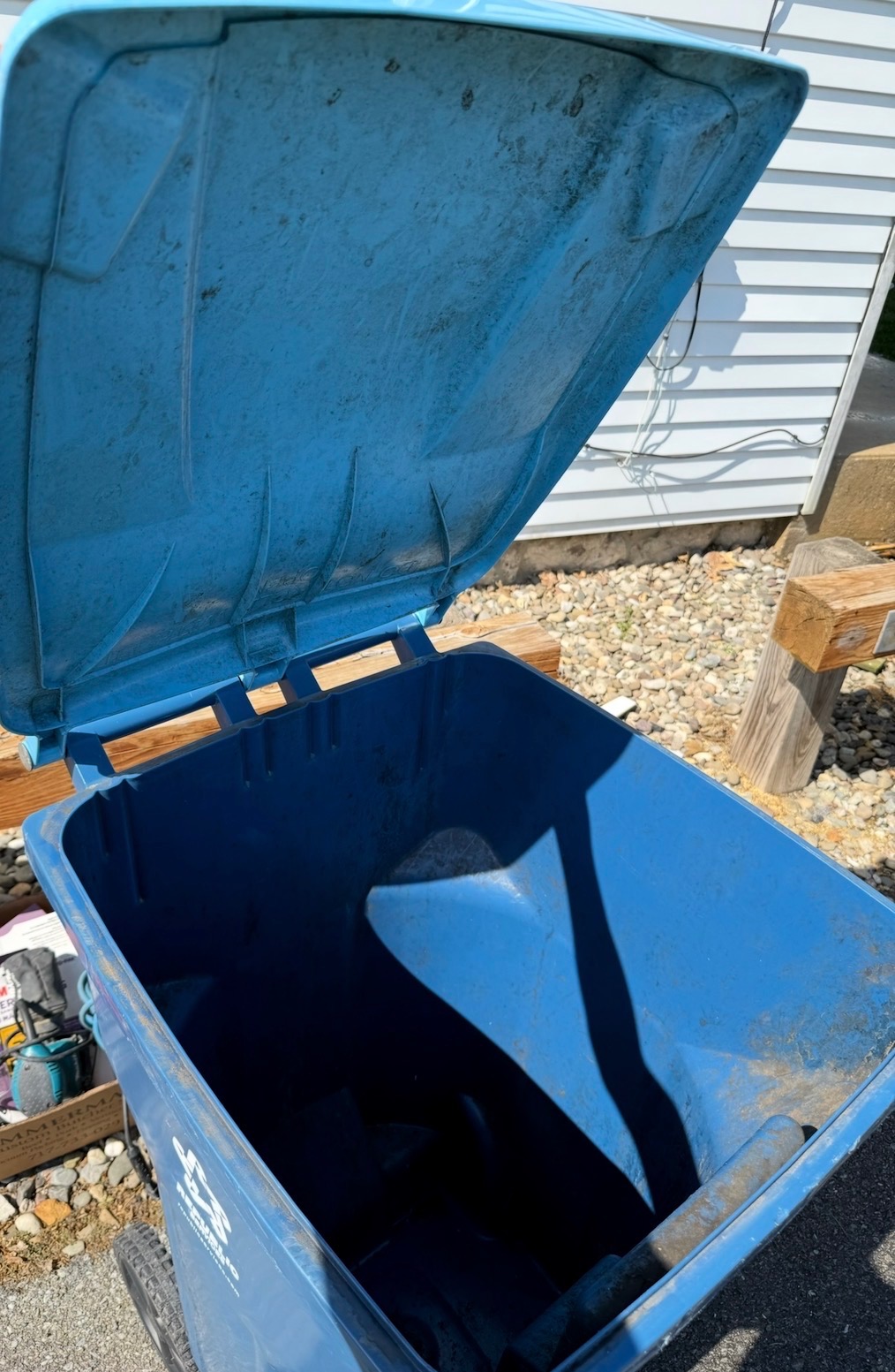 Trash tote caked with grime before cleaning